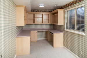 Office featuring crown molding, light colored carpet, and a textured ceiling