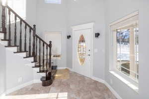 Tiled entryway with a high ceiling