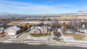 Snowy aerial view featuring a mountain view