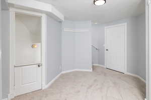 Landing featuring a children's play area under the stairs and the cold storage entry door