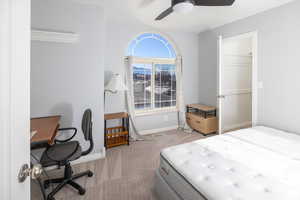 Carpeted bedroom with ceiling fan, a closet, and a walk in closet