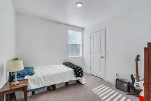 Carpeted bedroom with a textured ceiling