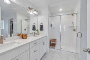 Bathroom with vanity and a shower with shower door