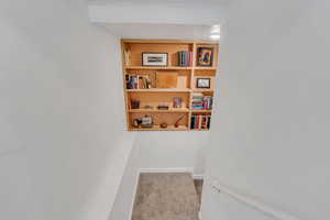 Hall featuring light colored carpet