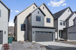 View of front of home with a garage and a mountain view