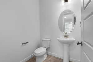 Bathroom featuring sink, hardwood / wood-style floors, and toilet