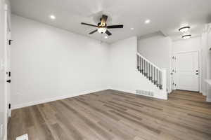 Empty room featuring ceiling fan and light wood-type flooring