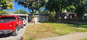 Ranch-style house featuring a front lawn