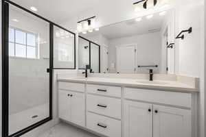 Bathroom featuring vanity and walk in shower