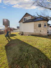 View of side of property featuring a yard