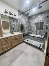 Bathroom featuring vanity and a shower with door