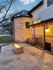 Snow covered patio featuring a fire pit