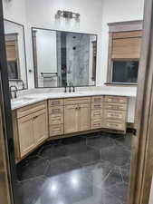 Bathroom with an enclosed shower and vanity