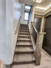 Stairs featuring crown molding