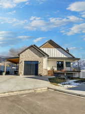 View of front of house featuring a carport and a garage