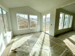 Unfurnished sunroom with lofted ceiling and plenty of natural light