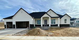 View of front of house featuring a garage and a porch