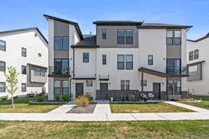 View of front facade with central AC unit and a front lawn