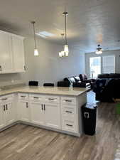 Kitchen featuring white cabinetry and decorative light fixtures