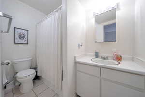 Bathroom featuring tile patterned flooring, vanity, and toilet