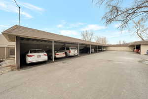 View of parking with a carport