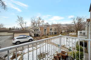 View of snow covered back of property