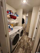 Washroom featuring washing machine and clothes dryer and dark hardwood / wood-style floors