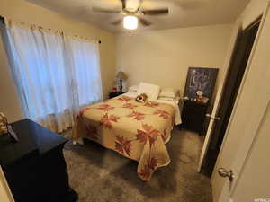 Carpeted bedroom with ceiling fan