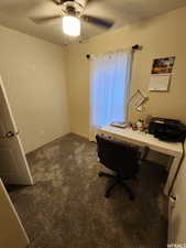 Carpeted office featuring ceiling fan