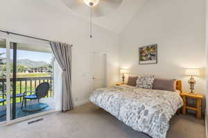 Bedroom with ceiling fan, access to exterior, a mountain view, and high vaulted ceiling