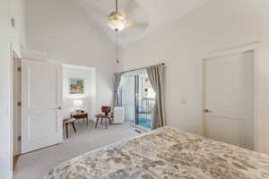 Carpeted bedroom with high vaulted ceiling, access to outside, and ceiling fan