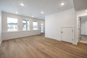 Empty room featuring light hardwood / wood-style floors and a wealth of natural light