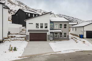 View of front facade featuring a garage and a mountain view