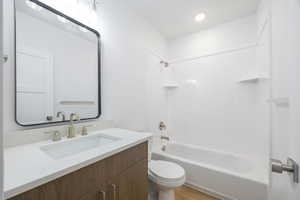 Full bathroom with vanity, shower / bathtub combination, and toilet