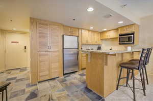 Full kitchen with stainless appliances and granite counter tops