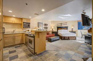 Full kitchen with stainless appliances and granite counter tops