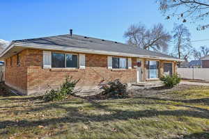 View of front of home with a front yard and a patio area