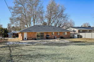 Back of property with a lawn, a patio, and central air condition unit