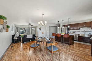 Living room featuring sink, ceiling fan, and light hardwood / wood-style floors