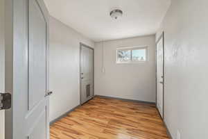 Corridor featuring light wood-type flooring