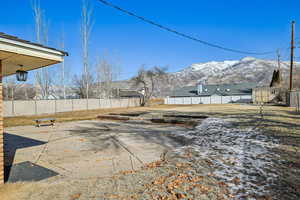 View of yard featuring a mountain view, a patio area, and a storage shed