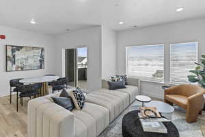 Living room with light hardwood / wood-style floors