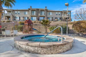 View of swimming pool with a playground