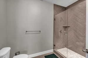 Bathroom with a shower with door and toilet