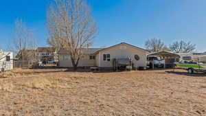 Back of property featuring a carport