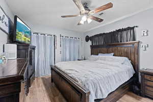 Bedroom featuring hardwood / wood-style floors and ceiling fan