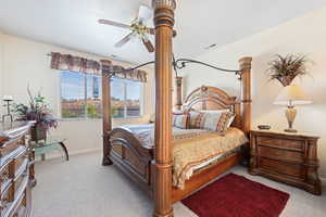 Bedroom with light carpet and ceiling fan