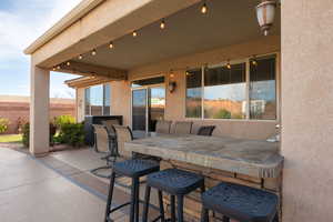 View of patio with fence and outdoor dining area