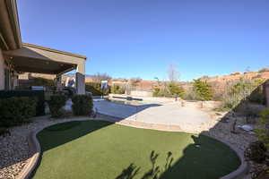 View of yard featuring a fenced in pool and a patio