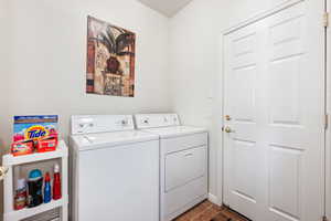 Clothes washing area featuring washing machine and clothes dryer